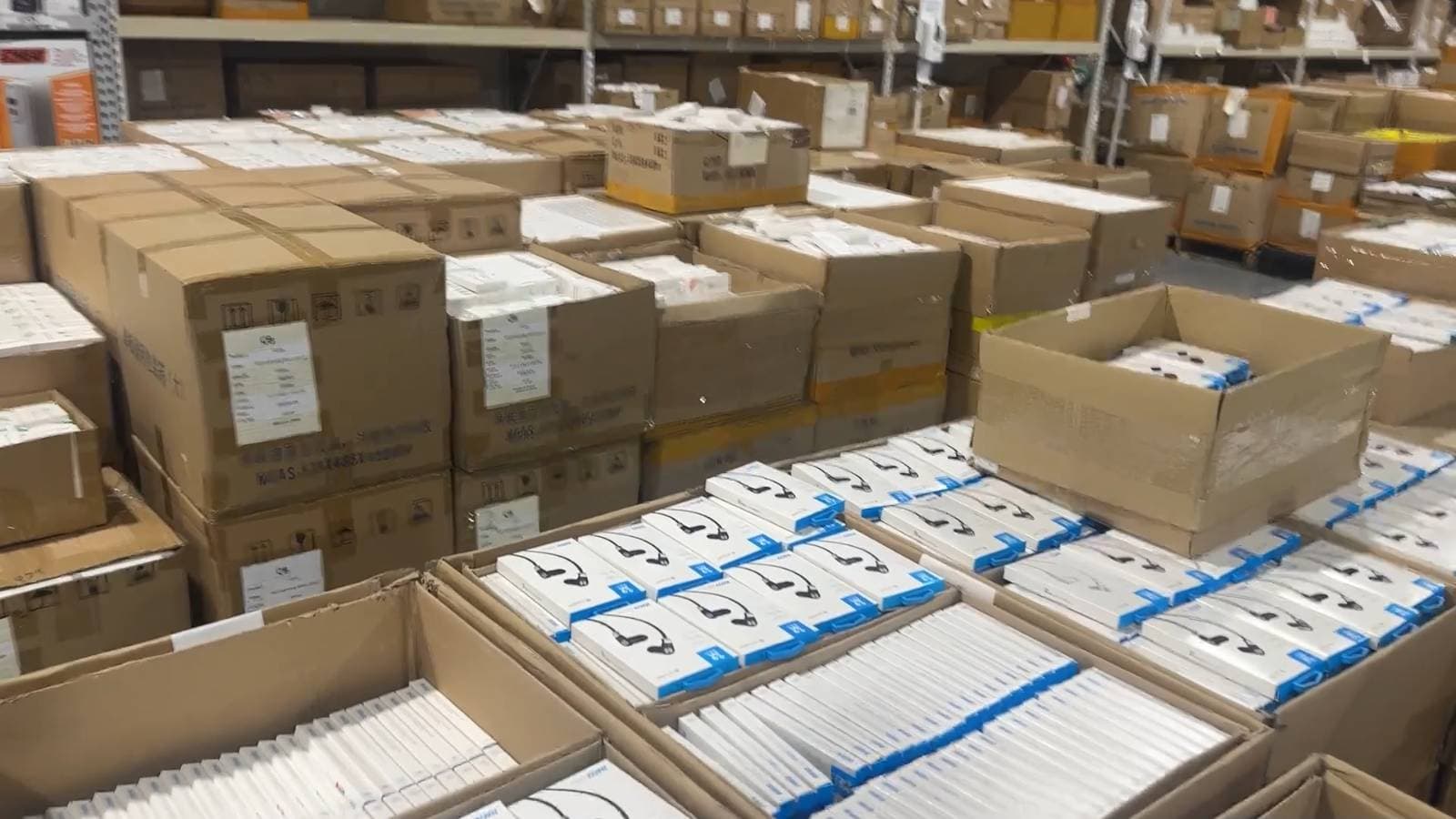 Rows of packaged electronics and boxed inventory in the HTM warehouse.